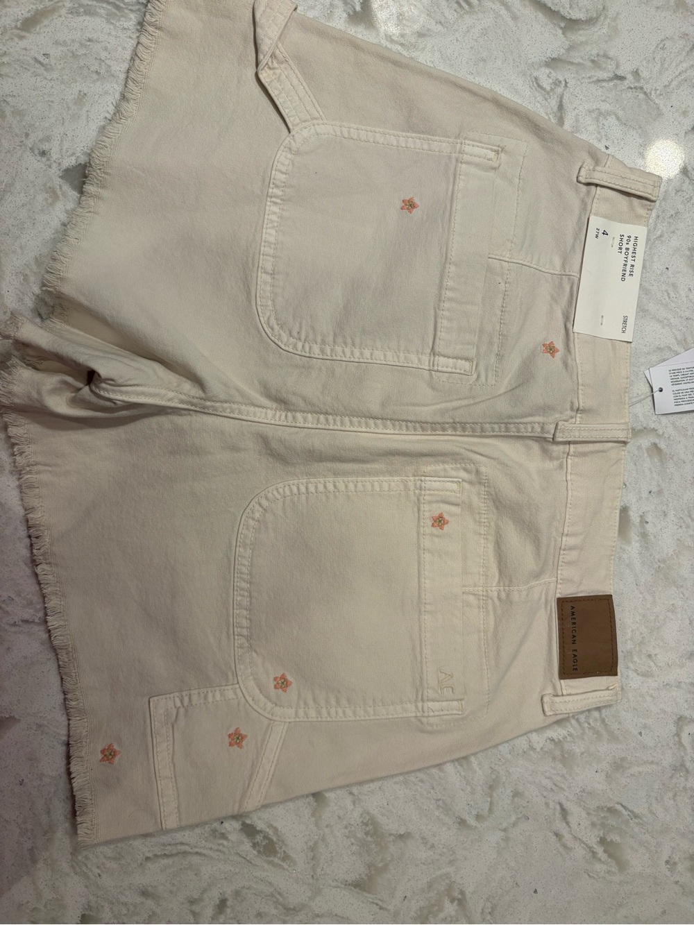 American Eagle Outfitters Cream Denim Cutoff Shorts with Pink Embroidery